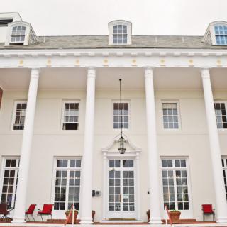 A grand white building with tall columns and large windows.