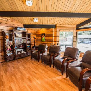 A cozy waiting room with comfortable chairs and wooden decor.