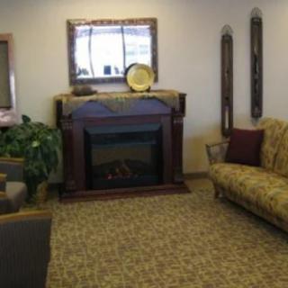 A cozy living room with a fireplace and comfortable seating.