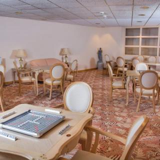 A cozy recreation room with game tables and comfortable seating.