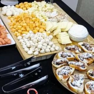 A gourmet cheese platter with a variety of cheeses and appetizers arranged for a buffet.
