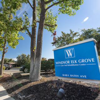Entrance sign for Windsor Elk Grove, surrounded by greenery.