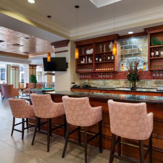 A cozy bar interior with upholstered seating and stylish decor.