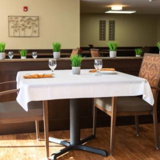 A neatly set dining table in a restaurant interior.