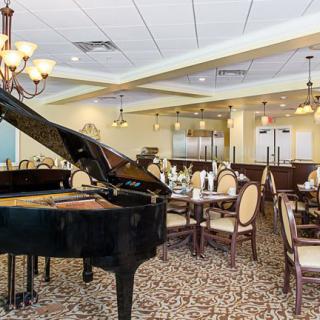Elegant restaurant interior featuring a grand piano and sophisticated dining setup.