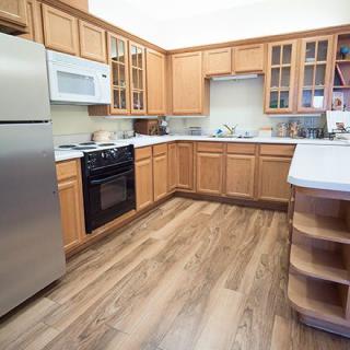 A modern kitchen with wooden cabinets and stainless steel appliances.