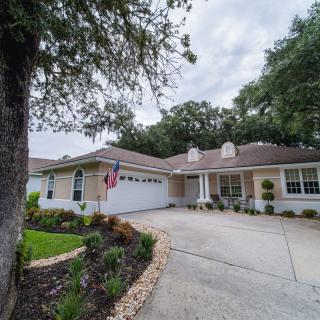 A suburban house with a well-maintained driveway and landscaping.