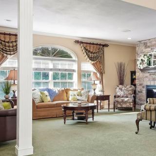 A cozy and elegantly decorated living room with comfortable furniture and a fireplace.