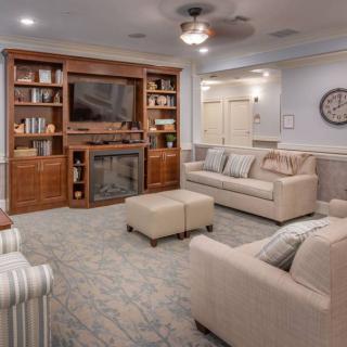 A cozy living room with comfortable seating and a large entertainment center.