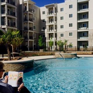 A relaxing day by the pool at a modern apartment complex.