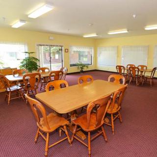 A spacious dining area with wooden tables and chairs, suitable for gatherings.