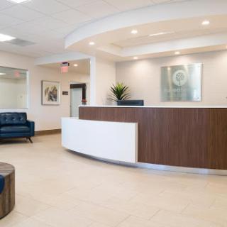 A modern reception area featuring a comfortable waiting space and contemporary decor.