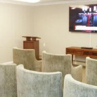 A small conference room with seating and a television for presentations.