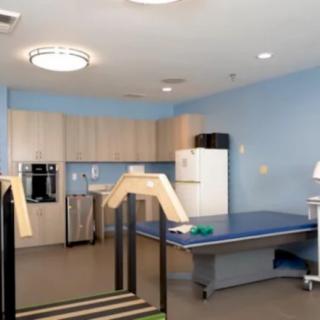 A rehabilitation room equipped with physical therapy tools and exercise equipment.