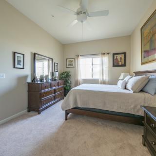 A cozy bedroom with a comfortable bed and wooden furniture.