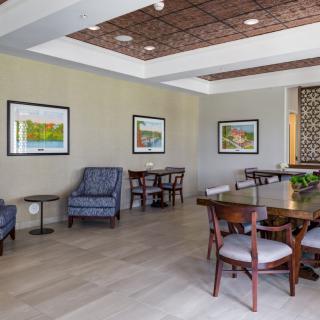 A modern waiting area with comfortable seating and artwork on the walls.