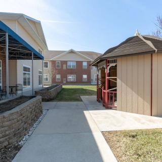 A walkway between buildings with a gazebo on the right.