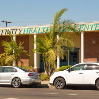 A view of Affinity Health Center showcasing its modern architecture and surrounding vehicles.