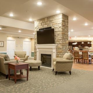A cozy and modern living room space featuring comfortable seating, a fireplace, and a television.