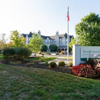 A scenic view of a building surrounded by landscaped gardens and trees.