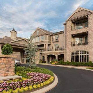 A beautifully designed residential building with elegant architecture and vibrant landscaping.