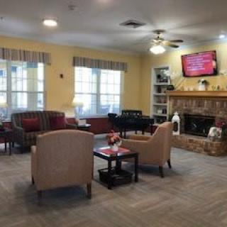 A cozy living room with comfortable seating, a fireplace, and a mounted television.
