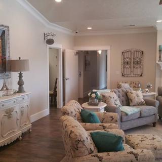 A cozy living room with comfortable sofas, armchairs, and tasteful decor accents.