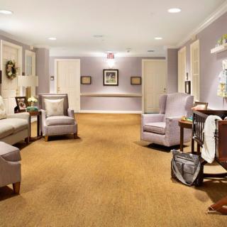 A cozy and well-decorated hallway with seating arrangements and soft lighting.