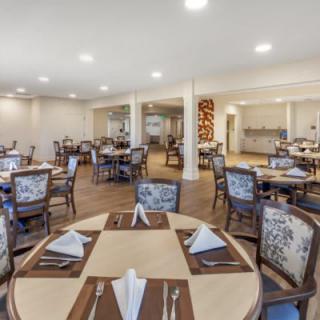 An elegant dining room setup with neatly arranged tables and chairs.