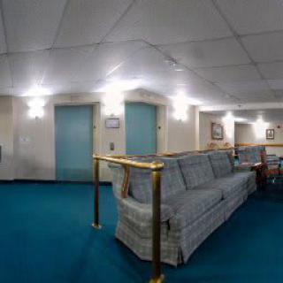 A hotel lobby area with seating and elevators.