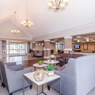 A modern lobby area with comfortable seating, tasteful decor, and elegant lighting.