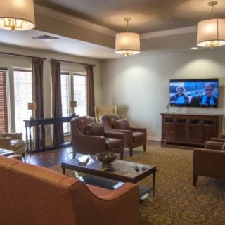 A cozy living room featuring modern furniture and a television.