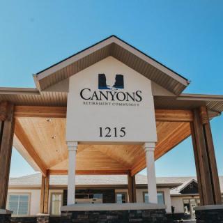 Entrance to Canyons Retirement Community with visible signage and address.