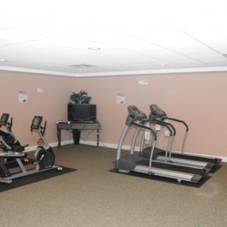 A small gym room equipped with treadmills and exercise bikes.