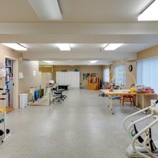 A spacious and well-lit rehabilitation room in a healthcare facility.