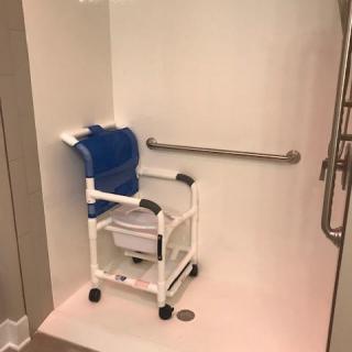 An accessible shower with a mobility wheelchair designed for ease of use.