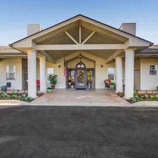 A large building entrance with grand columns and a welcoming porch.