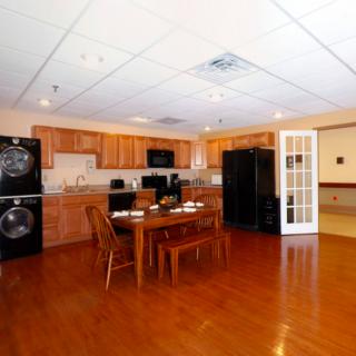 A spacious kitchen and dining area featuring modern appliances and wooden flooring.