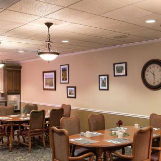 An empty dining area with neatly set tables and a warm, inviting interior design.