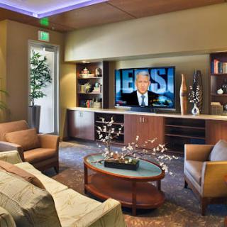 A modern living room with comfortable seating and a large television.