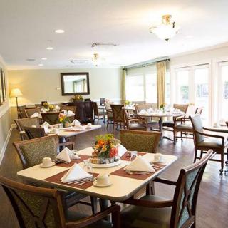 A well-decorated dining area with neatly arranged tables and chairs, ready for guests.