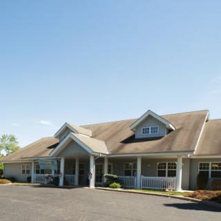 A single-story building with a sloped roof and a welcoming entrance.