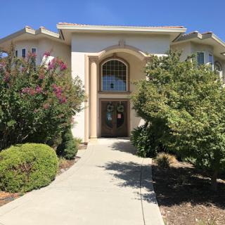 A beautifully landscaped front entrance of a modern house.