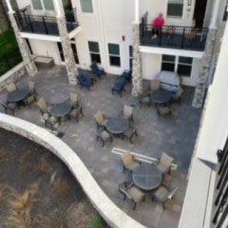 Aerial view of an outdoor patio area with tables and chairs next to a building.