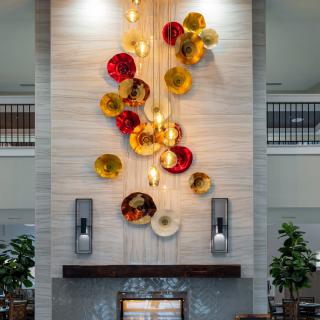 A modern indoor wall installation featuring vibrant, colorful sculptures.