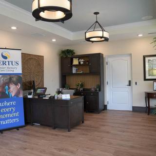 Modern office reception area with a desk, banner, and decorative lighting.