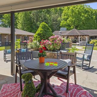 A cozy outdoor seating area surrounded by lush greenery, perfect for relaxation and enjoying nature.