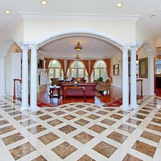 A luxurious living room with arched doorways and elegant furnishings.
