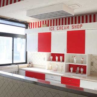 A modern ice cream shop with a red and white themed interior.