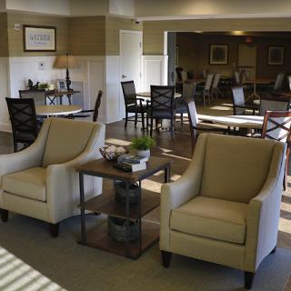 A modern lounge area featuring comfortable beige chairs and stylish decor.